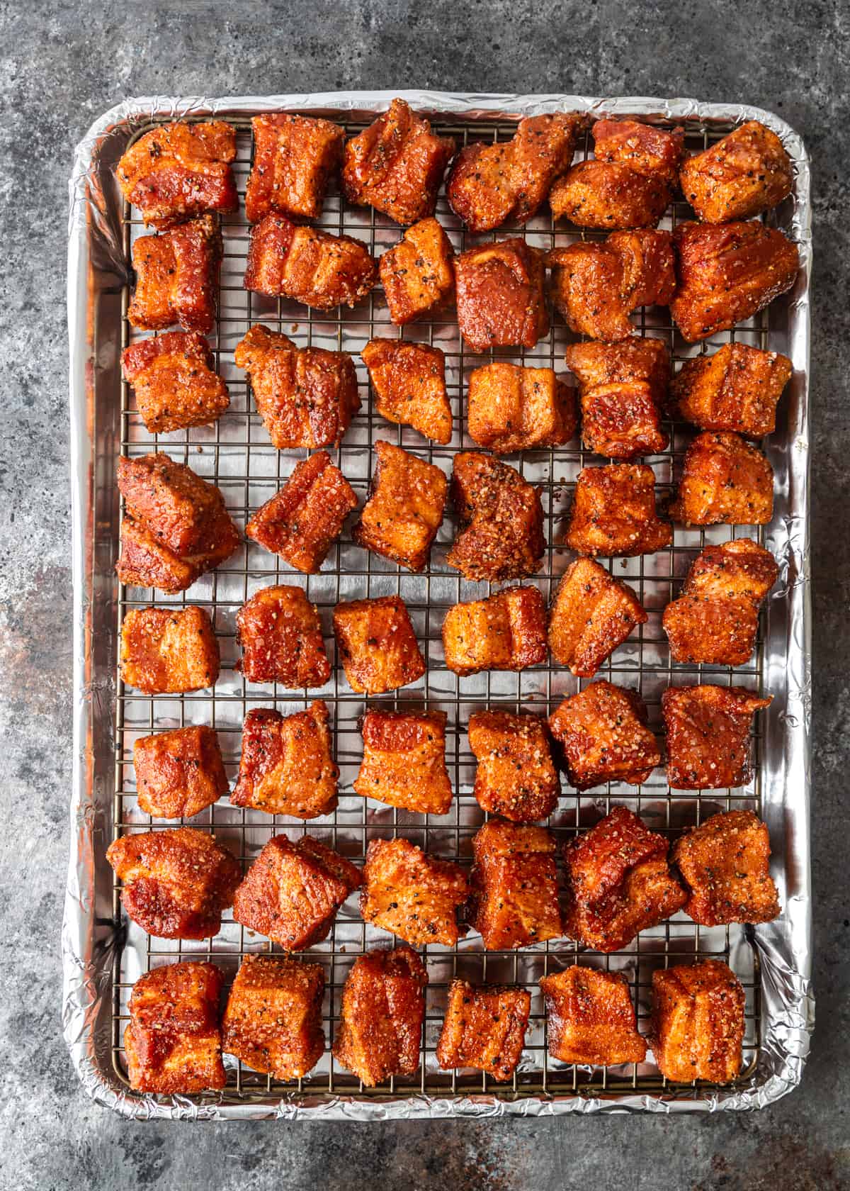 overhead shot of pork belly on a baking sheet