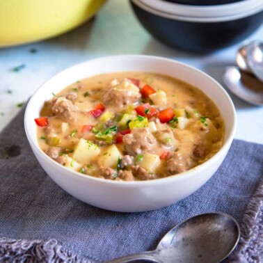 Potato Cheeseburger Soup - Creamy and loaded with chucks of seasoned, seared hamburger, chunks of potatoes, loads of cheese and diced pickles on top! keviniscooking.com