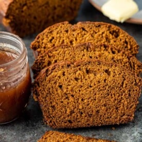 slices of banana pumpkin bread next to jar of pumpkin butter