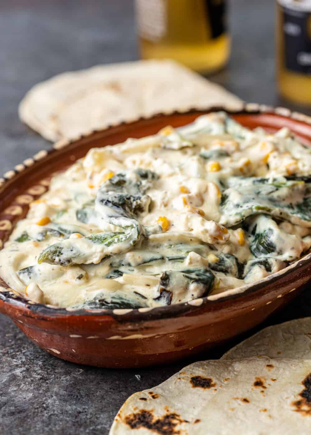 brown serving dish filled with rajas con crema