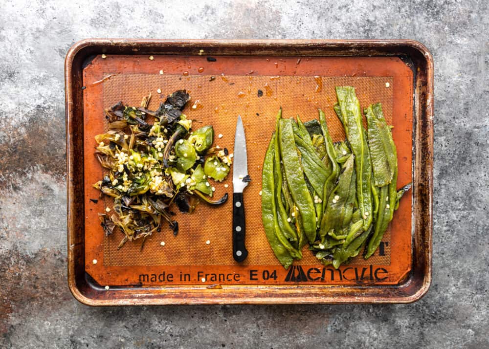 overhead image: skins and seeds of roasted poblano peppers next to the peppers cut into slices