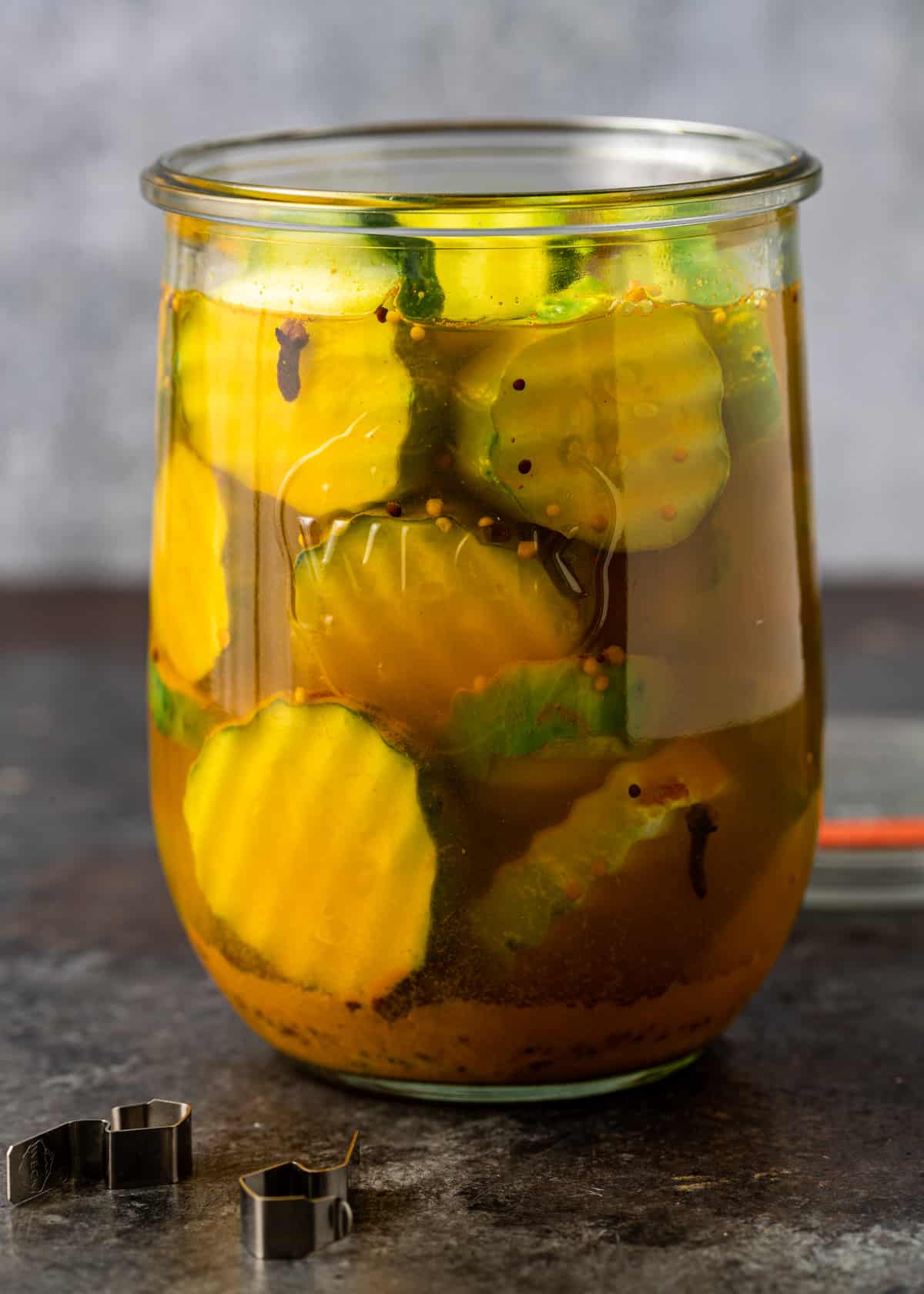 a glass jar full of bread and butter pickles