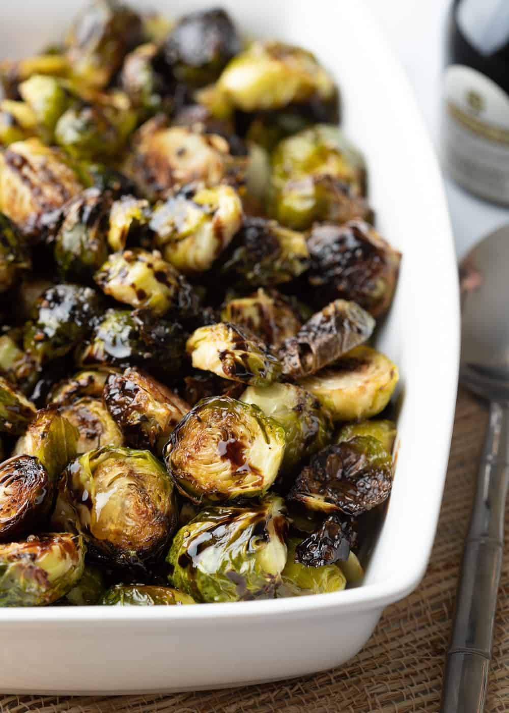 balsamic honey roasted Brussels sprouts in white serving dish