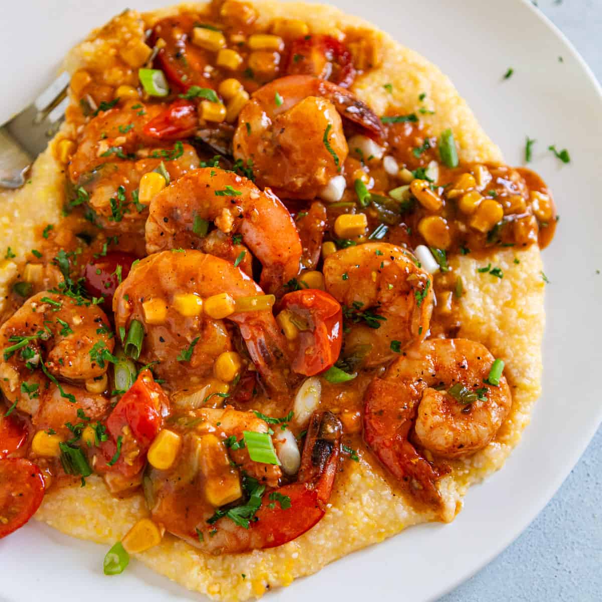 overhead: shrimp and grits on a white plate