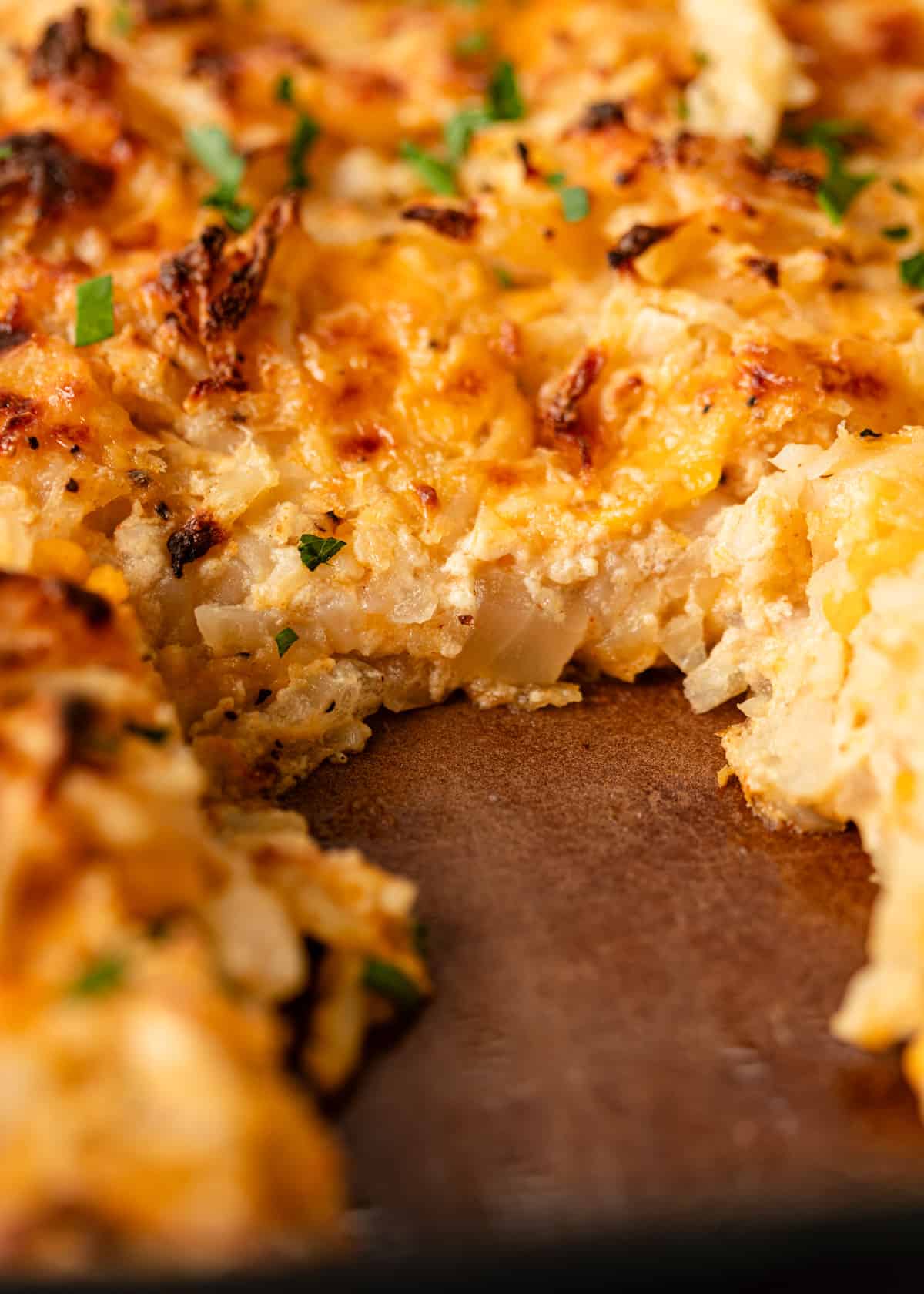 extreme closeup: hashbrown casserole with cheese