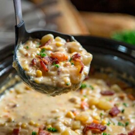 close up: ladle full of crock pot corn chowder