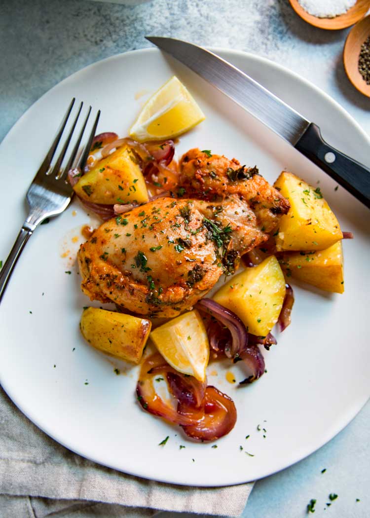 This Spanish Roasted Chicken and Potatoes is a one pan, super easy mid-week dinner for the family. Chicken thighs are seasoned with smoked paprika and lemon juice, slow roasted with red onions, garlic and potatoes and sherry. 