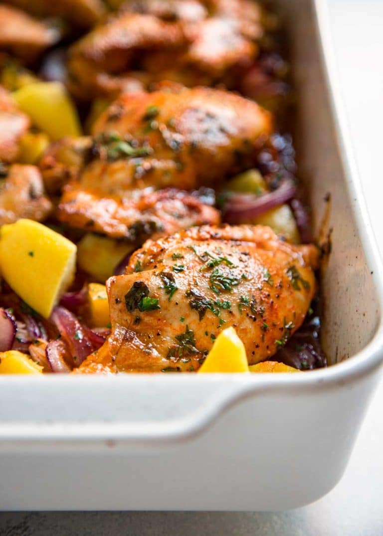 This Spanish Roasted Chicken and Potatoes is a one pan, super easy mid-week dinner for the family. Chicken thighs are seasoned with smoked paprika and lemon juice, slow roasted with red onions, garlic and potatoes and sherry. 