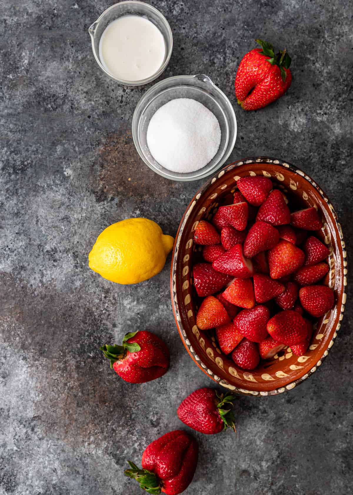 overhead of ingredients for strawberries and cream ice pops