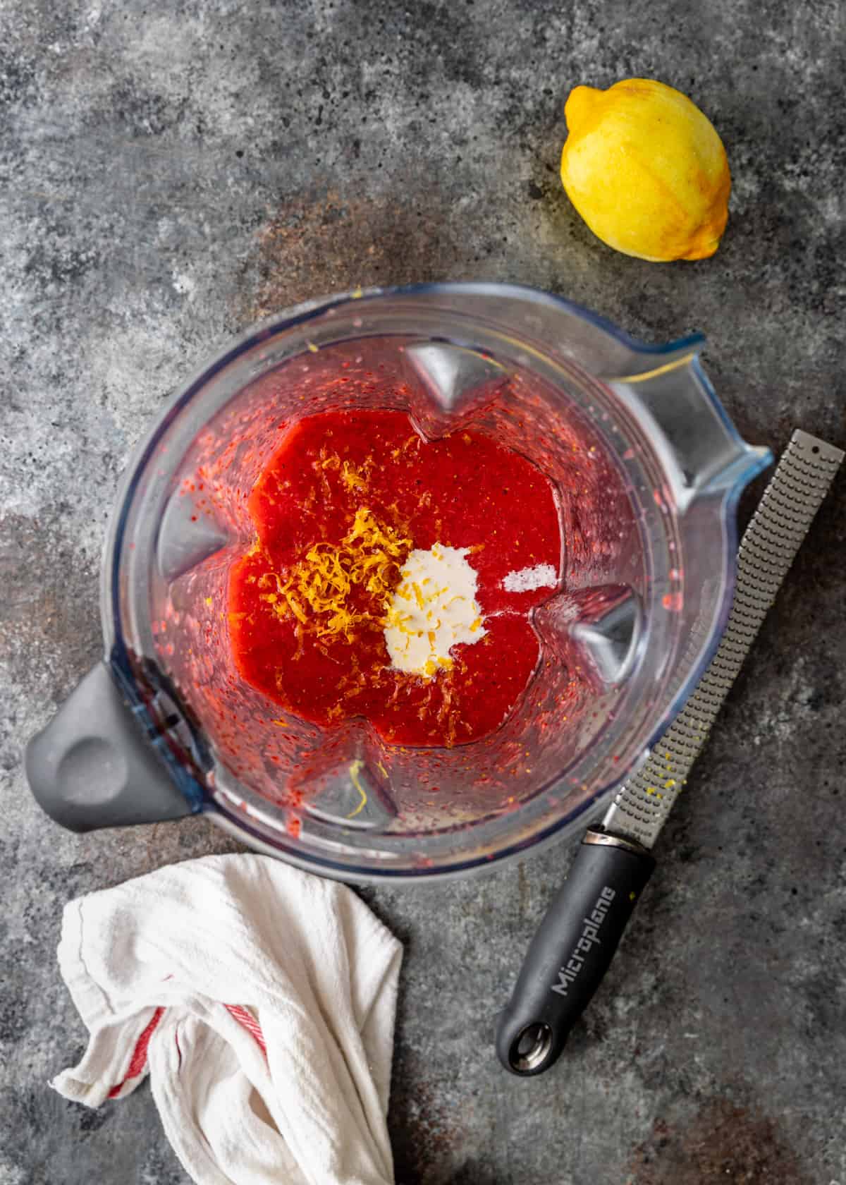 overhead of strawberry and cream ice pops ingredients in a blender