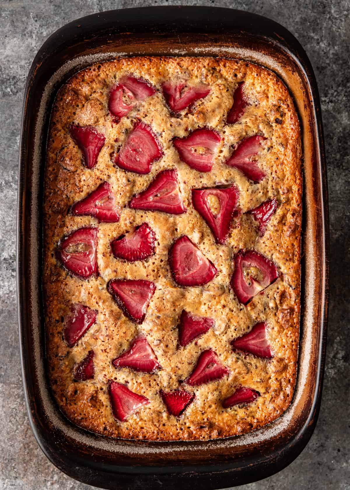 overhead: baked cornmeal cake with strawberries showing