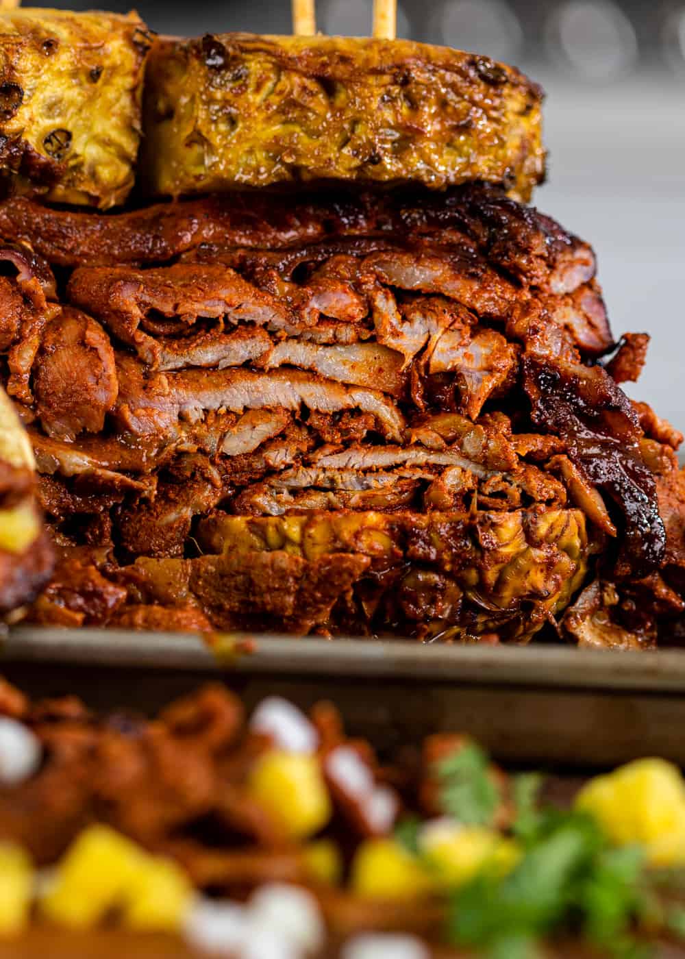 A close up of sliced tacos al pastor