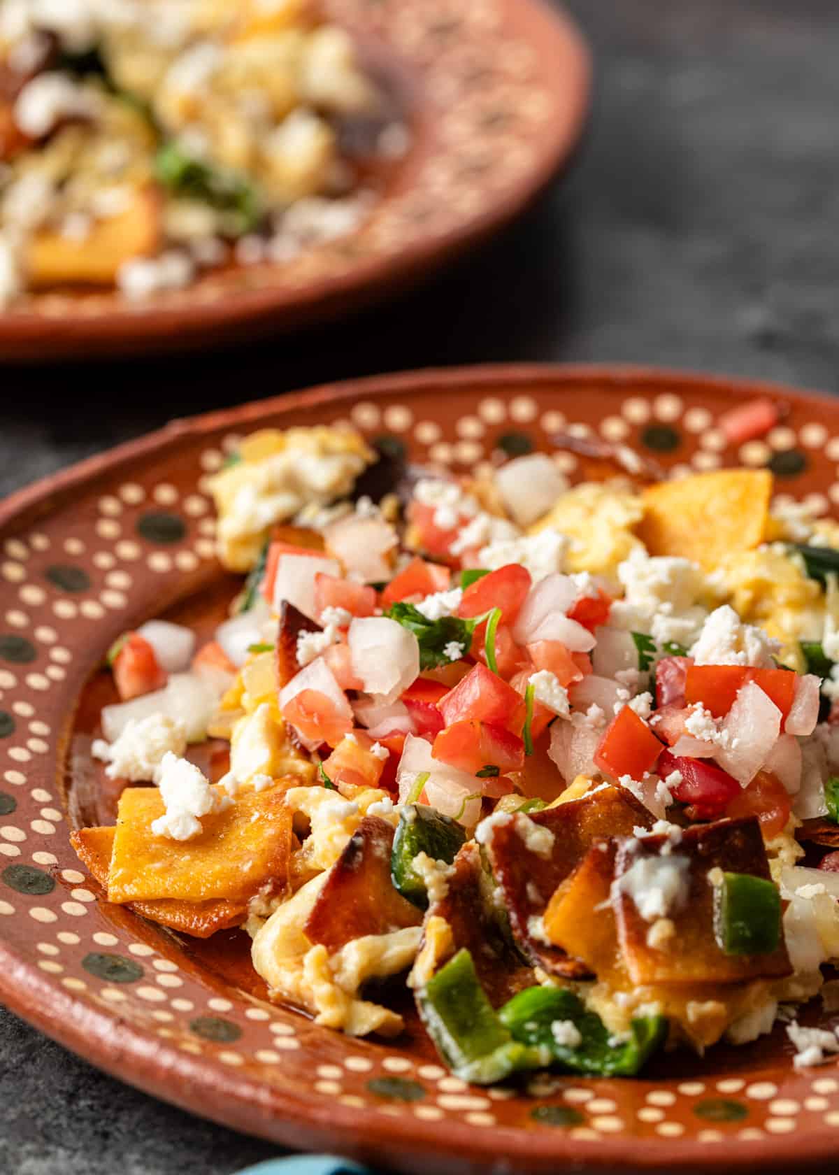 side view closeup: a plate of Tex Mex migas with fresh pico de gallo on top