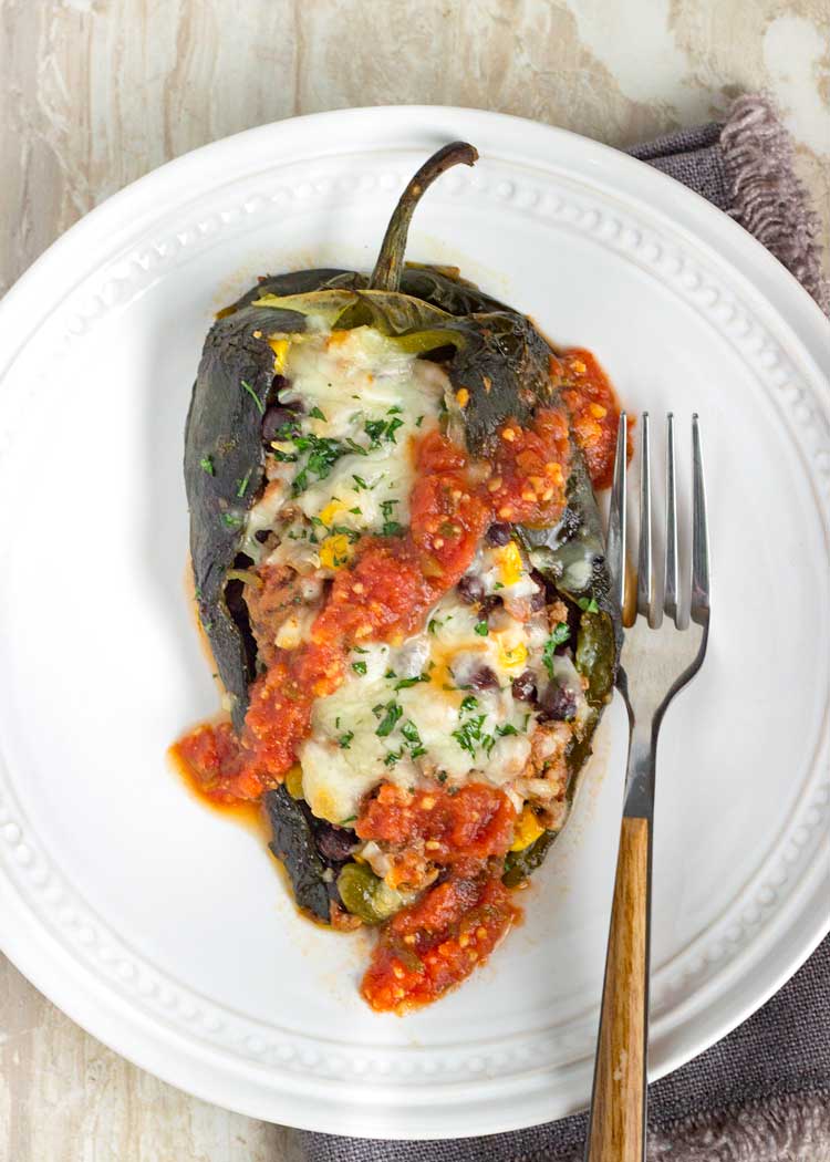 tex mex stuffed green peppers on white plate