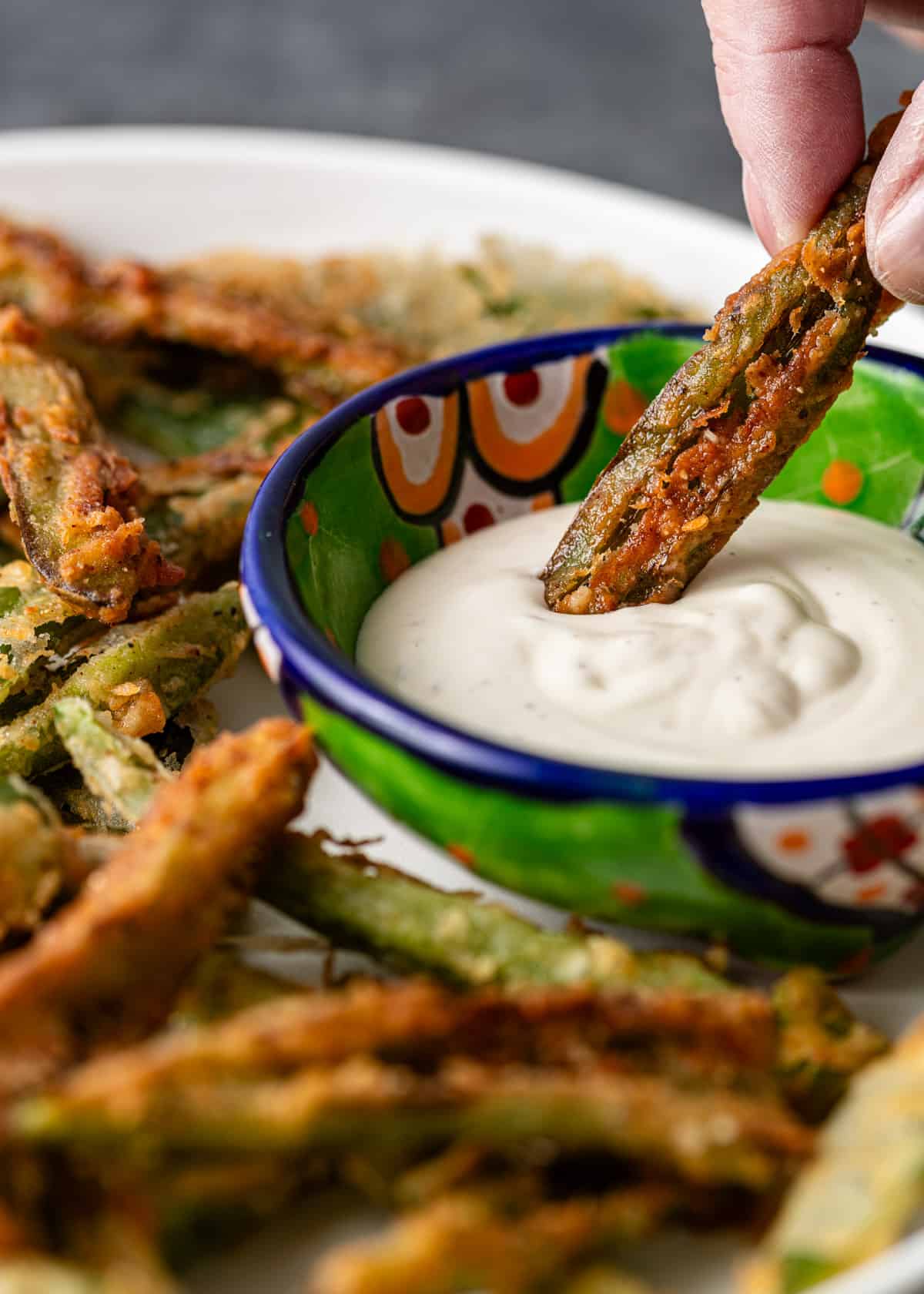 closeup: dipping a Texas toothpick into a white sauce