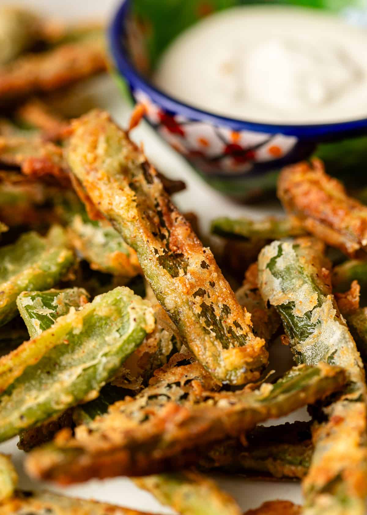 extreme closeup: crispy fried Texas toothpicks with a bowl of dipping sauce showing