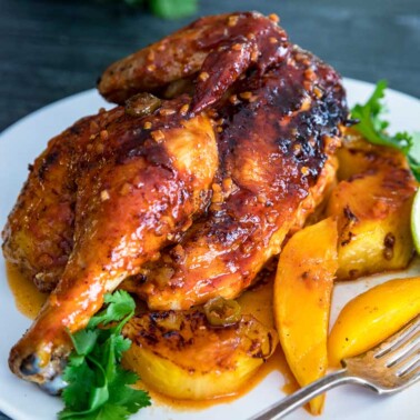 A plate of tropical roasted chicken and mangoes